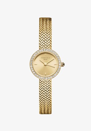 Montre en or avec un bracelet tressé et un cadran rond. La lunette est ornée de cristaux transparents, et le cadran présente des marquages minimalistes.