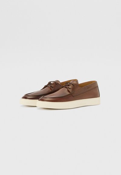 Brown leather shoes featuring a rounded toe design, lace-up closure, and a light-colored rubber sole. Smooth texture with minimal detailing.