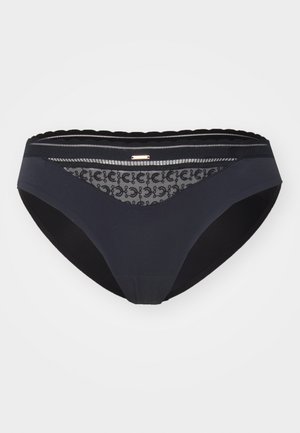 Black bikini briefs with a smooth front, lace detailing on the back, and scalloped edges. Includes a small metallic accent.