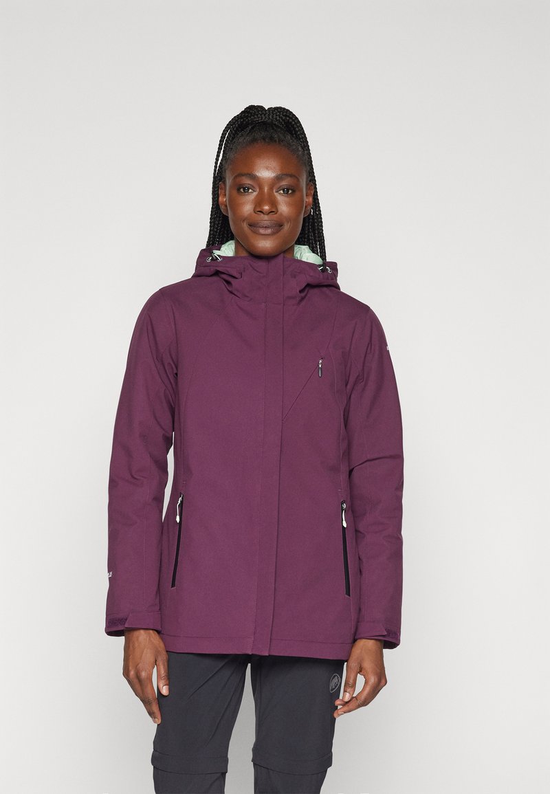 Veste imperméable violette avec capuche, deux poches zippées, cordons de serrage ajustables et doublure contrastante vert clair. Tissu texturé.