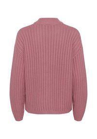 Ribbed knit sweater in soft pink, featuring a relaxed fit, high collar, and dropped shoulders, with textured fabric throughout.