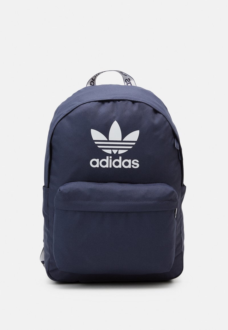 Navy blue Adidas backpack with front zip pocket and white trefoil logo on a plain background.