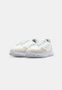 Sneakers in white, grey, and beige. Made of mesh and suede, featuring a padded tongue, laces, and a textured rubber outsole.