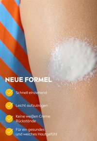 Cream being applied to skin with orange and blue striped fabric in background, accompanied by German text about new formula benefits.