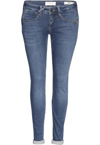 Úzké džíny v tmavě modrém denimu s středním pasem, obsahující pět kapes, poutka na opasek a ohrnuté manžety. Hladká textura a minimální švy.