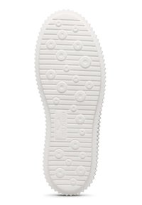 Semelle de chaussure en caoutchouc blanc avec des motifs de traction circulaires et linéaires, présentant une surface texturée et un bord dentelé pour une meilleure adhérence.