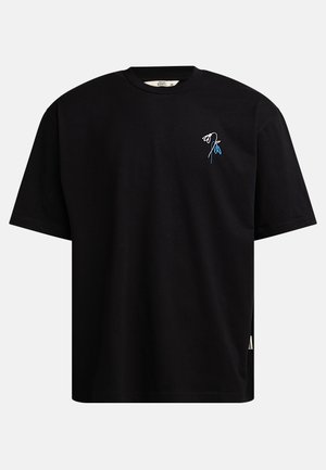 Black cotton t-shirt with short sleeves, round neckline, featuring a small blue and white flower embroidery on the chest. Side tag detail.