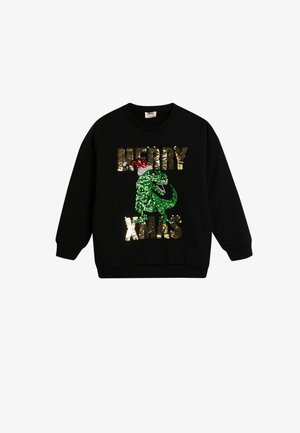 Sudadera negra con un gráfico de dinosaurio de lentejuelas verdes, lleva un gorro de Santa rojo y texto en lentejuelas doradas que dice "FELIZ NAVIDAD". Cuello redondo.