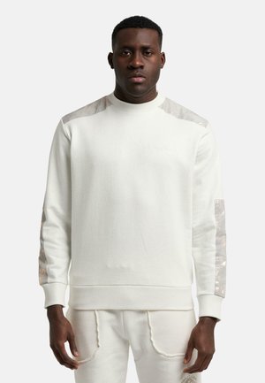 Hvid sweatshirt med teksturerede, skinnende detaljer på skuldre og ærmer. Rund hals, ribbede manchetter og kant. Blødt stof med minimal branding.