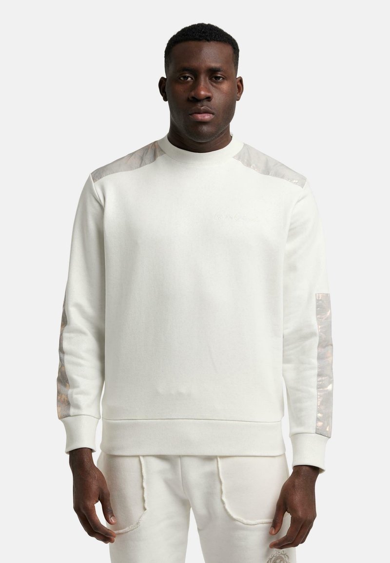 Weißer Sweatshirt mit strukturierten, glänzenden Akzenten an den Schultern und Ärmeln. Rundhals, gerippte Bündchen und Saum. Weicher Stoff mit minimaler Markenkennzeichnung.