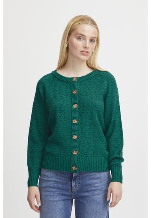 Green knit cardigan featuring a textured pattern, round neckline, and brown buttons down the front. Ribbed cuffs and hem for enhanced fit.