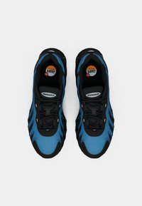 Pair of blue and black Nike Air Max sneakers viewed from above on white background.