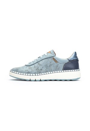 Zapatilla deportiva azul claro con diseño floral perforado, suela blanca con costuras azules, talón azul oscuro y cierre de cordones, mostrada sobre fondo blanco.