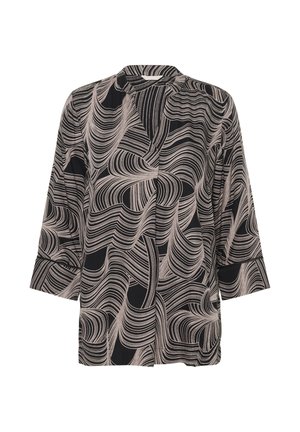 Blouse à motifs noir et beige avec une coupe ample, des manches longues et un col rond, ornée de motifs en vagues et d'une texture douce.