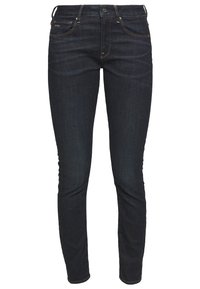 Mörkblå skinny jeans i denim, utrustade med fem fickor, dragkedja och kontrasterande sömmar vid kanterna.