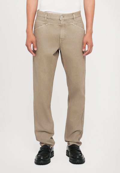 Beige denim jeans with a straight fit, five pockets, and contrasting stitching. Features a button closure and loops for a belt.