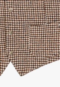 Tessuto a motivo houndstooth marrone e bianco con una trama texture, dotato di quattro bottoni e una tasca a toppa sul lato sinistro.