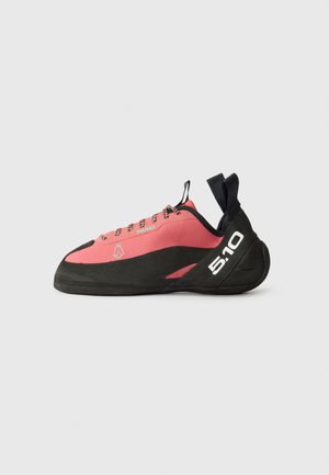 Climbing shoe featuring a pink upper, black rubber sole, dials for lacing, and a pull tab at the heel. Engraved logo on the side.