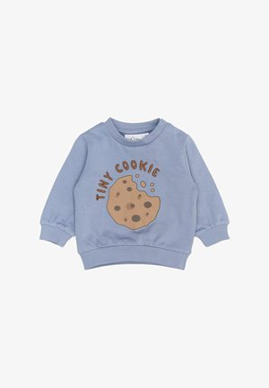 helesinine dressipluus pikkade varrukatega, millel on küpsise graafika ja tekst "TINY COOKIE" pruunis värvuses. Pehme puuvillane kangas, elastsed mansetid.