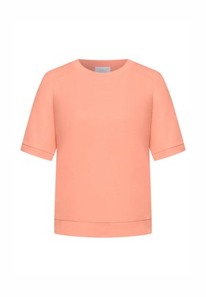 Růžová blůza s krátkými rukávy, kulatým výstřihem a manžetami na rukávech, zobrazena na bílém pozadí.