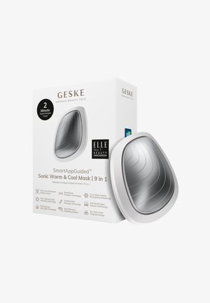 Sonic Warm & Cool Mask har et slankt sølvskall med ribbet tekstur. Emballagen viser produktdetaljer og logoer tydeligt.