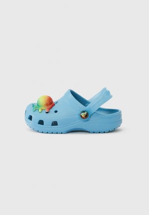 Light blue plastic clog with ventilation holes, a back strap, and a colorful ice cream charm accent on the front. Textured surface.