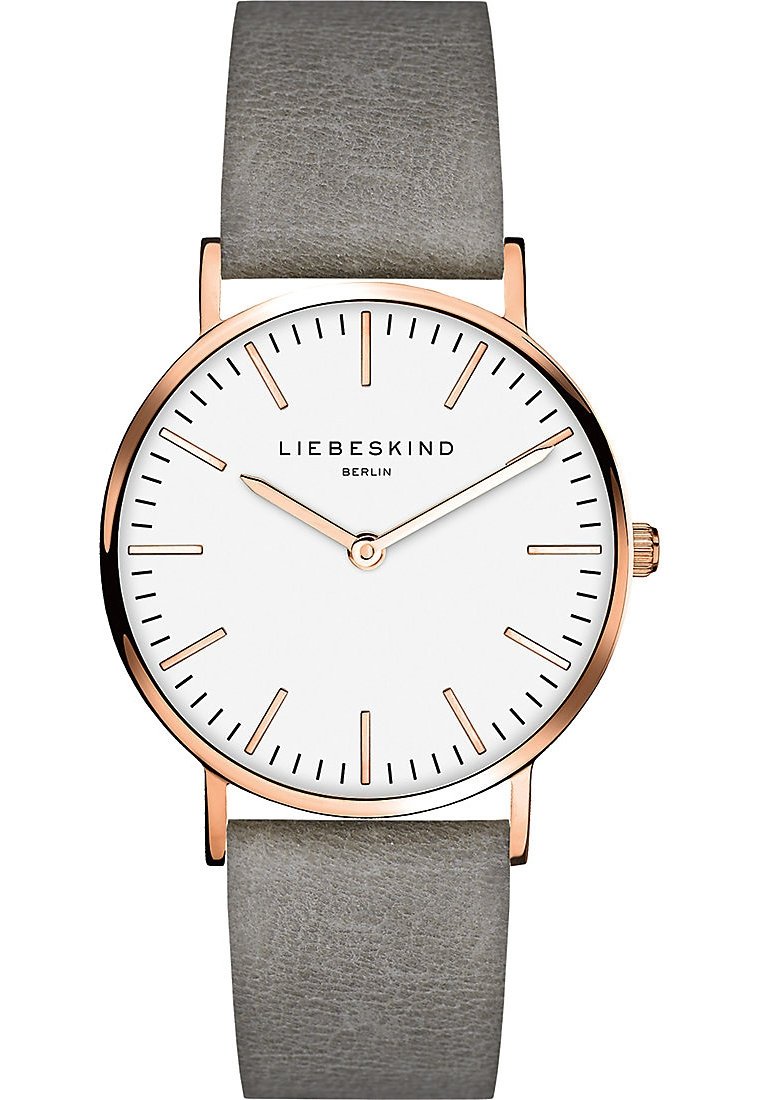 Runde Uhr mit Zifferblatt in Weiß, roségoldenen Akzenten, schmalem grauen Lederarmband, minimalistischen Stundenmarkierungen und einer kleinen Krone zur Einstellung.