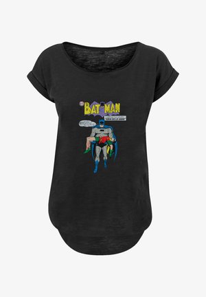 Black t-shirt with a loose fit featuring a comic-style graphic of Batman carrying Robin. The design includes bright colors and text elements.