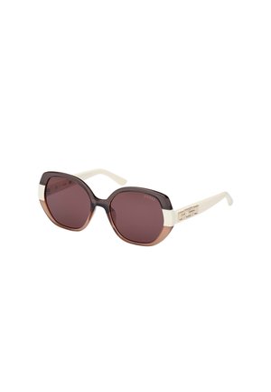 Brown gradient sunglasses with a wide, angular design. The frame features white accents and a metallic logo on the side.