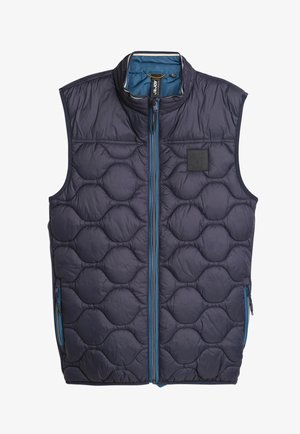 Marineblauwe, gewatteerde vest met een hoge kraag, voorzien van een volledige ritssluiting en twee zijzakken. Accentueert met blauwe ritsen en een logo patch.