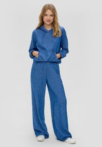 Blauwe, gebreide loungewear set met een capuchon met trekkoord en wijde broekspijpen. De stof heeft een gewatteerde afwerking en een losse pasvorm.