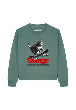 Green sweatshirt with a black and white cat jumping on a skateboard above large red "Savage" text and smaller descriptive text below.