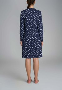 Abito navy a maniche lunghe con motivo floreale bianco, alla lunghezza del ginocchio, in tessuto morbido, silhouette dritta e scollo rotondo.