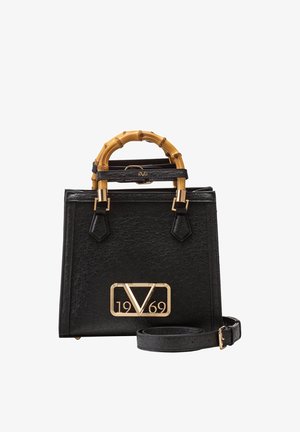 Black textured handbag with bamboo handles, gold "V 1969" logo, and detachable shoulder strap on white background.