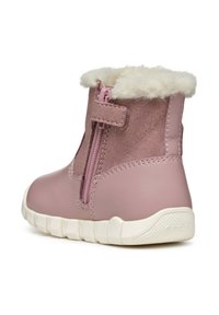 Stivale alla caviglia in pelle rosa con bordo in pelliccia sintetica, chiusura con zip laterale, suola in gomma e suola bianca texturizzata. Decorato con dettagli in camoscio.