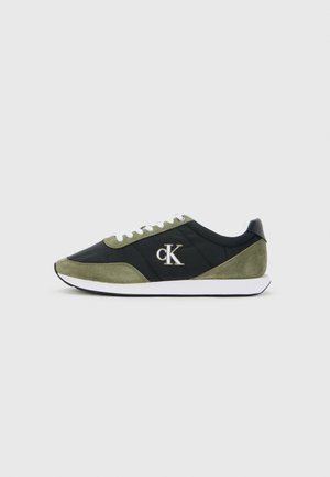 Black and olive green sneaker with white laces and sole, featuring a "cK" logo on the side, shown from a side view on plain background.