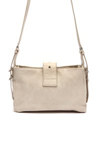 Beige leather crossbody bag with a textured surface, magnetic snap closure, adjustable strap, and minimalist design.