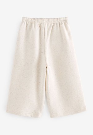 Light beige shorts made of soft fabric, featuring a relaxed fit, elastic waistband, and a subtle speckled pattern in pastel colors.