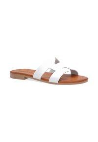 White leather slide sandal with two wide straps, brown textured footbed, and flat light tan sole. Minimalist design with no embellishments.