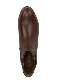 Brown leather ankle boot with a pebbled texture, rounded toe, side buckle detail, and a contrasting white stitching outline.