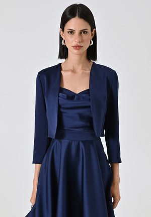 Navy blue satin dress with a structured jacket, featuring a cowl neckline and three-quarter sleeves, smooth texture, and flared skirt.