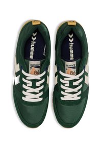 Green sneakers with a textured finish, white stripes, and a navy insole. Features white laces and a yellow accent on the heel.