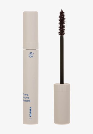 Closed beige mascara tube labeled Drama Volume Mascara and open wand with dark bristle brush coated in mascara.