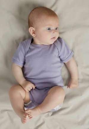 Light purple cotton onesie with short sleeves, soft texture, round neckline, and snap buttons at the bottom, laid on a light gray surface.