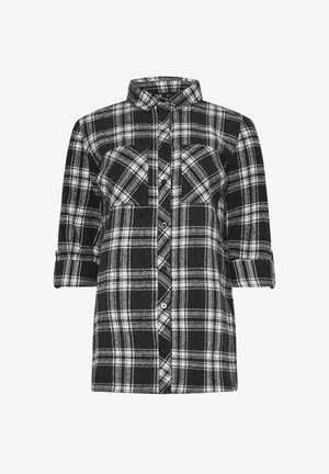 Musta-valkoinen ruudullinen flanelli paita, jossa on napitettava etuosa, kaksi rintataskua ja käärityt hihat. Pehmeä rakenne ja rento istuvuus.