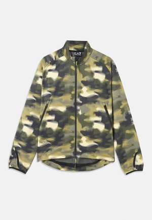 Kādas camo jakas zaļos un bēšos toņos, ar rāvējslēdzēja fronti, augstu apkakli un sānu kabatām ar sietu apakšmalā. Viegls audums.