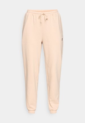 Beežid dressipüksid pehmest kangast, millel on elastne vöökoht paelaga ja mansettidega pahkluud. Lihtne, minimalistlik disain.