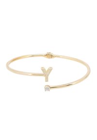 Gold-tone bangle featuring a "Y" accent set with clear cubic zirconia, and a small round stone, open-ended design for adjustable fit.