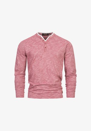 Red long-sleeve henley shirt made of textured cotton, featuring a white contrast collar and three button placket.