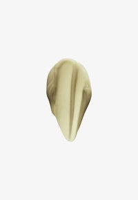 Smooth beige cream or lotion smear with a pointed shape on a white background.